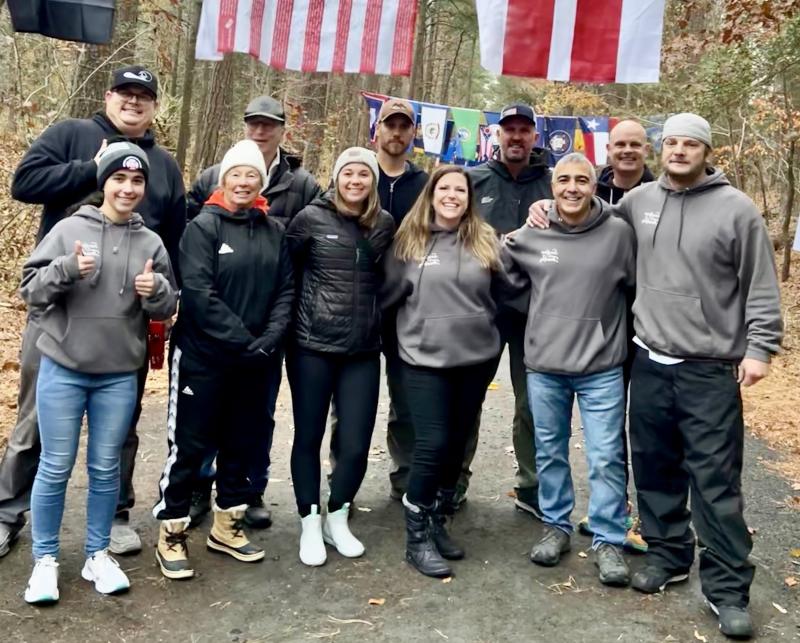 Fourteen runners in the Rehoboth Beach Seashore Marathon and Half Marathon raised more than $14,000 for the Surfgimp Foundation. Volunteers helped out during the races. Shown in back are Mike D'Antoni, Jason Bradley, Ed Martin, Brad Dennehy and Dan Malley. In front are (l-r) Bella Polizzi, Deb Hauth, Kasey Beeson, Melanie Liesener, Chris Polizzi and Jack Frederick. SUBMITTED PHOTOS